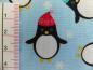 Preview: Patchworkstoff Pinguine mit Mütze auf helltürkis. Von Timeless Treasures. Detailansicht.